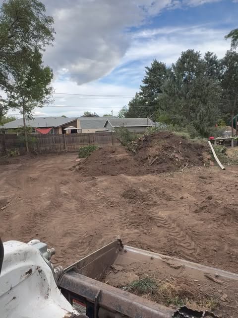 A backyard graded and prepped with a skid steer before a new build